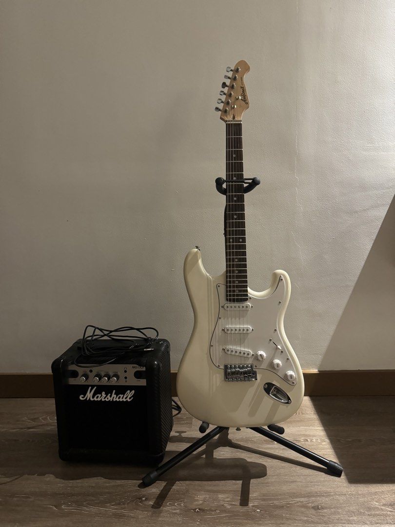 Electric Guitar and Marshall Amplifier Bundle (Category: Musical Instruments) located in Paranaque City. Submitted by jennifer_18 (Listing ID 1470899099, Image 1). Description: - Complete Electric Guitar Set -Amplifier: Marshall MG10CF 10-watt with carbon fiber finish - Classic white Stratocaster-style body, rosewood fretboard, white pickguard, 3 single-coil pickups, 1 volume, 2 tone knobs, and a 5-way pickup selector - Condition: Excellent worki
