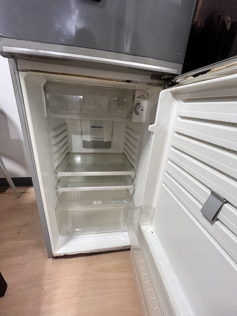 Electrolux White-Westinghouse Two Door Refrigerator Grey (Category: Refrigerators and Freezers) located in Del Monte. Submitted by jennyluistro (Listing ID 1470931868, Image 2). Description: - Brand/Model: Electrolux White-Westinghouse two-door fridge - Color: Grey with travel and decorative magnets on the front door - Layout: Top freezer compartment and bottom main fridge section - Features: Interior glass shelves, crisper drawer, and door bins 
