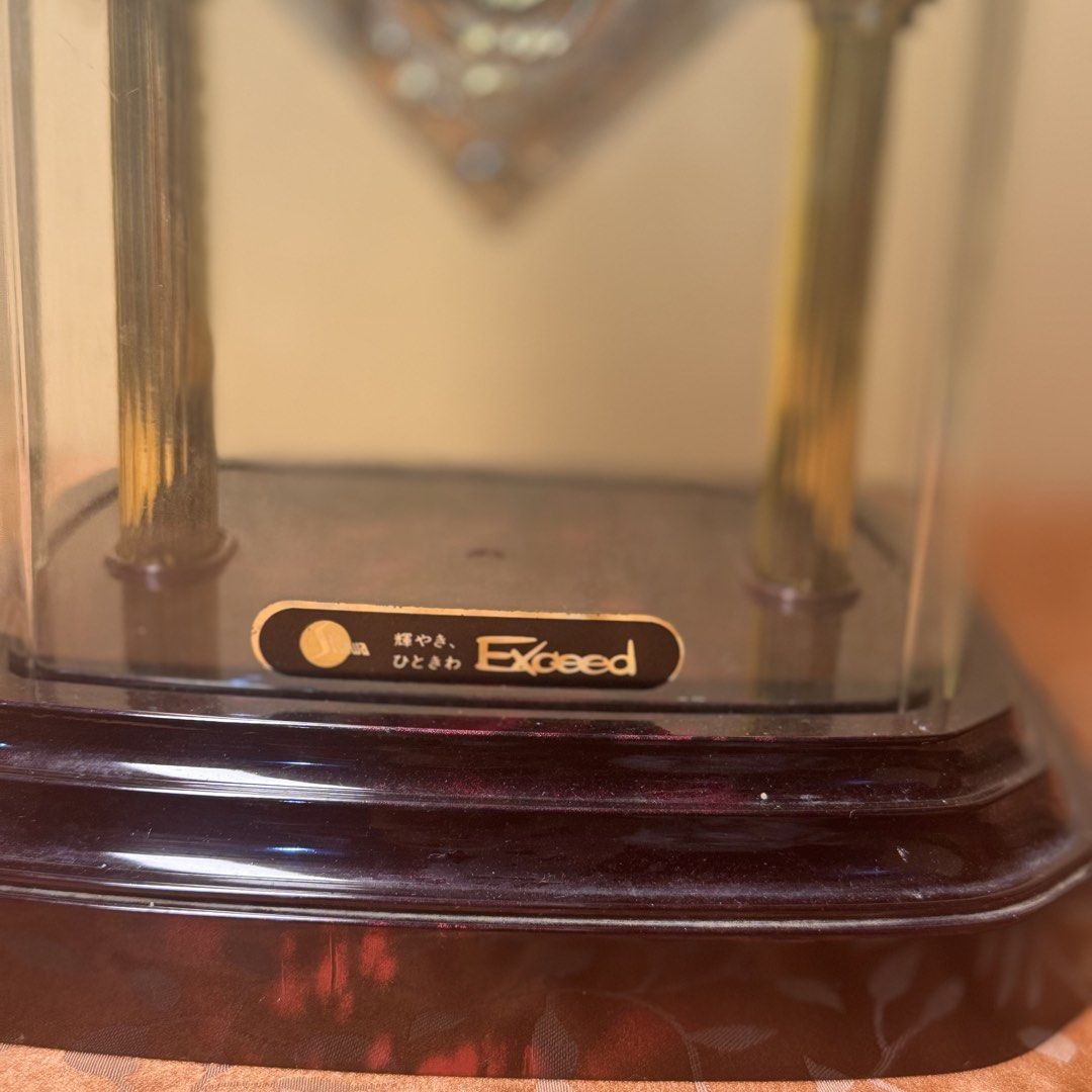 Elegant Japanese Showa Exceed Dome Table Clock with Marble-Pattern Dial (Category: Clocks) located in Pasig City. Submitted by msjazzylad (Listing ID 1470905527, Image 2). Description: Brand/Movement: Showa Exceed Quartz (Japan Movement) Design & Features: Elegant glass/acrylic dome cover with gold twin pillar support design. Unique purple marble-textured clock face with vintage-style hands and clear numeric markers. Classic dark wood-finish base
