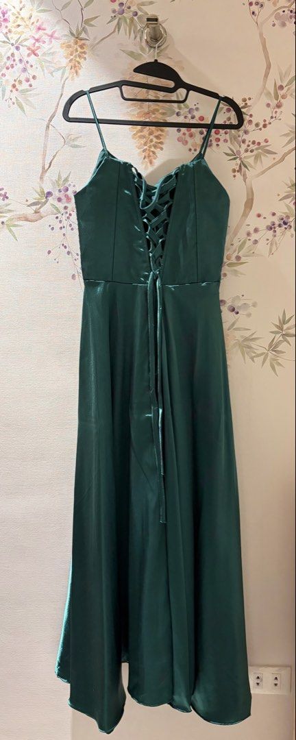 Emerald Green Satin Spaghetti Strap Maxi Dress (Category: Dresses) located in Cavite. Submitted by eunizcaimol (Listing ID 1470915278, Image 2). Description: - Color & Material: Emerald green, silky satin with a slight sheen - Design: Spaghetti straps, pleated bust detailing, and flowy floor-length skirt - Back Details: Corset-style lace-up design with adjustable ribbon ties - Size: 36B bust, 30 waist, 5’2 ht - Condition: Worn once for a wedding,