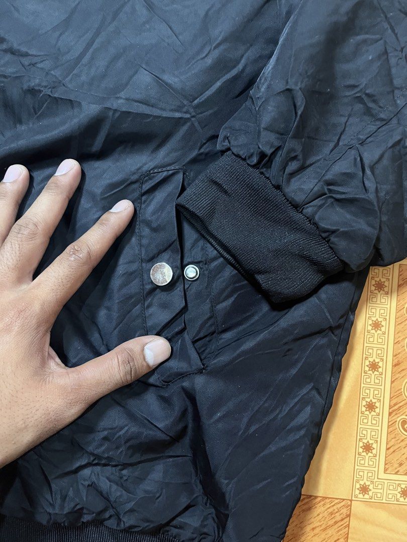 Emporio Armani Black Bomber Jacket (Category: Coats, Jackets and Outerwear) located in Kidapawan. Submitted by azythrift (Listing ID 1470822860, Image 3). Description: - Authentic Emporio Armani black bomber jacket 23x26 unisex - Classic ribbed collar, cuffs, and hem for a snug fit - Secure front zip closure with convenient waist snap-button pockets - Stylish embroidered script logo on the chest - Signature small eagle patch on the left sleeve - 