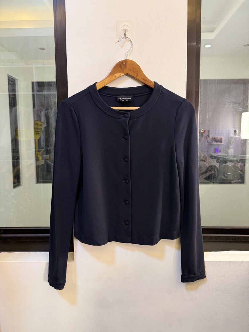 Emporio Armani Button-Down Collarless Cardigan Jacket (Category: Coats, Jackets and Outerwear) located in Paranaque City. Submitted by preluxeshop_ph (Listing ID 1470809777, Image 2). Description: Brand: Emporio Armani -Style: Button-Down Collarless Cardigan Jacket / Long-Sleeve Knit Top -Color: Dark Navy Blue -Design Features: Clean collarless crew neckline, matching fabric-covered front buttons, fitted long sleeves, and vertical seam detailing 