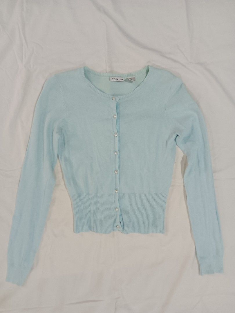 Energie Light Blue Button-Up Cardigan Size M (Category: Longsleeves) located in Imus. Submitted by brightgem.de2dc2 (Listing ID 1470784762, Image 2). Description: - Brand/Model: Energie Cardigan - Color: Light blue - Size: Medium - Material: 51% ramie, 32% nylon, 17% cotton - Details: Pearl-like front buttons, ribbed hem and cuffs - Condition: Preloved with a small, faint stain on the ribbed part (kindly check the last photo for reference).