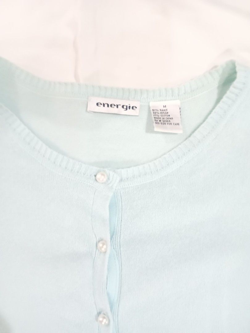 Energie Light Blue Button-Up Cardigan Size M (Category: Longsleeves) located in Imus. Submitted by brightgem.de2dc2 (Listing ID 1470784762, Image 3). Description: - Brand/Model: Energie Cardigan - Color: Light blue - Size: Medium - Material: 51% ramie, 32% nylon, 17% cotton - Details: Pearl-like front buttons, ribbed hem and cuffs - Condition: Preloved with a small, faint stain on the ribbed part (kindly check the last photo for reference).