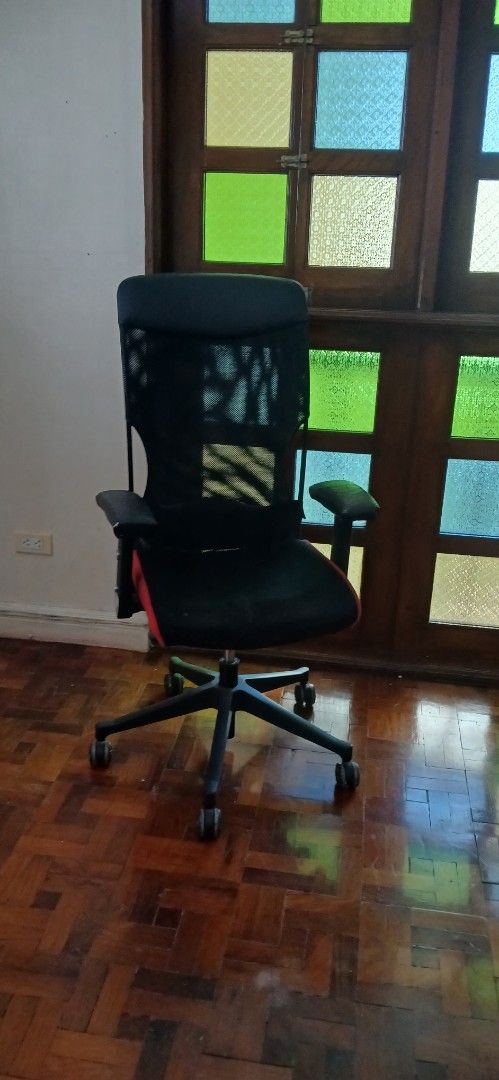 Ergonomic Mesh Office Chair with Red Trim (Category: Office Furniture & Fixtures) located in Pasig City. Submitted by annamariam38525 (Listing ID 1470781644, Image 2). Description: - Ergonomic black mesh office chair with stylish red accents - Breathable mesh back support for all-day comfort during work or study - Adjustable armrests and standard height adjustment lever - Sturdy black star base with smooth-rolling caster wheels.