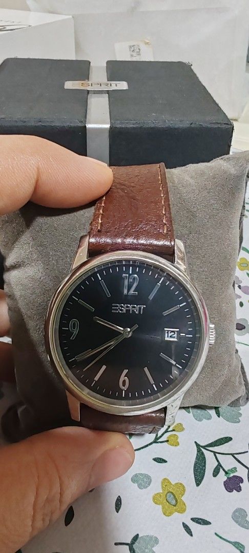 Esprit ES100S61004 Quartz Watch with Brown Leather Strap (Category: Women's Watches) located in Makati City. Submitted by plazatienda (Listing ID 1470748185, Image 1). Description: - Brand/Model: Esprit ES100S61004 - Movement: Battery quartz movement for accurate timekeeping - Dial: Black dial with numerical markers at 12, 6, and 9, plus a convenient date window at 3 o'clock - Case: Stainless steel circular silver case - Strap: Original strap rep