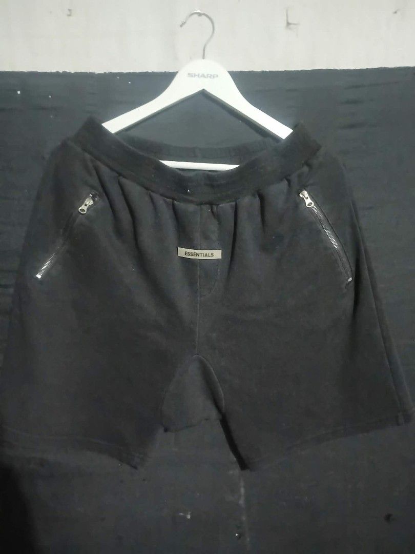 Essentials Black Zipper Shorts (Category: Shorts) located in Angeles City. Submitted by ukaythrift2.0 (Listing ID 1470877240, Image 1). Description: - Color: Classic Black - Material: Premium heavy cotton fleece for ultimate comfort and warmth - Features: Elastic waistband for a secure fit and convenient zippered pockets on both sides - Branding: Centered rubberized Essentials logo patch - Condition: Clean, well-maintained overall - Perfect for d
