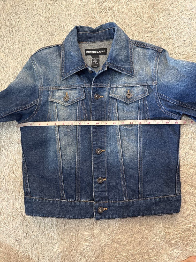 Express Jeans Women's Blue Denim Jacket (Category: Coats, Jackets and Outerwear) located in Quezon City. Submitted by dropdeadprices (Listing ID 1470778761, Image 3). Description: - Brand: Express - Style: Classic blue denim jacket - Features: Front button closure, chest pockets, classic collar, and long sleeves with buttoned cuffs - Details: Faded wash finish and adjustable button tabs at the back hem - Material: Sturdy cotton denim - Fit/Use: G