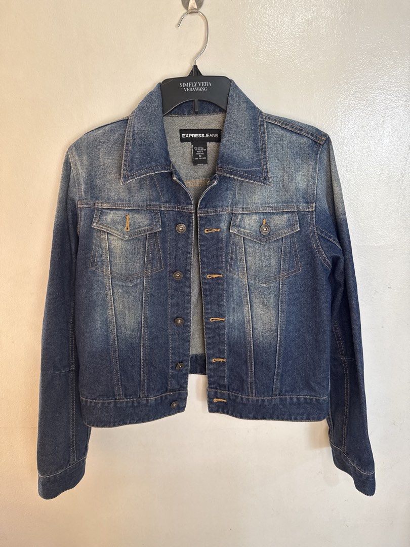 Express Jeans Women's Blue Denim Jacket (Category: Coats, Jackets and Outerwear) located in Quezon City. Submitted by dropdeadprices (Listing ID 1470778761, Image 1). Description: - Brand: Express - Style: Classic blue denim jacket - Features: Front button closure, chest pockets, classic collar, and long sleeves with buttoned cuffs - Details: Faded wash finish and adjustable button tabs at the back hem - Material: Sturdy cotton denim - Fit/Use: G