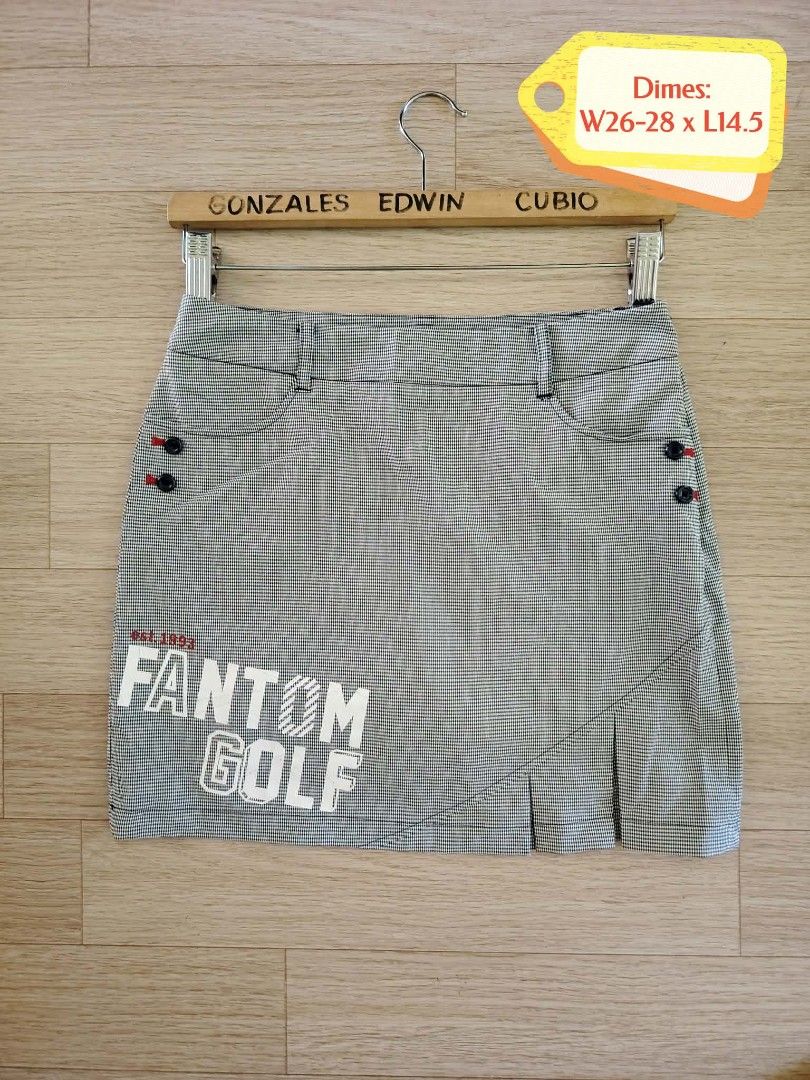 Fantom Golf Houndstooth Skort with Built-in Shorts (Category: Skirts) located in Nasipit. Submitted by edwingonzales498-69377 (Listing ID 1470927920, Image 2). Description: - Brand: Fantom Golf - Style: Black and white houndstooth golf skort with built-in white shorts for extra coverage - Details: Large graphic branding near the hem and on the back pocket, button accents, and functional pockets - Fit & Size: Flat lay waist 26 to 28 inches, length