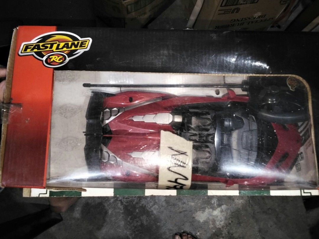 Fast Lane RC Lamborghini Veneno Red Remote Control Car (Category: Vintage Collectibles) located in Manila. Submitted by grl.mon31 (Listing ID 1470871007, Image 3). Description: - Model: Lamborghini Veneno-inspired Fast Lane RC car - Scale: 1:16 with striking red aerodynamic body and rear wing - Frequency: 40MHz for smooth control - Features: Black wheels, underside battery compartment, and steering alignment dial - Inclusions: Complete with contr