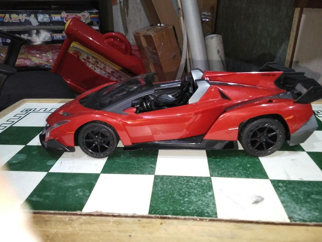 Fast Lane RC Lamborghini Veneno Red Remote Control Car (Category: Vintage Collectibles) located in Manila. Submitted by grl.mon31 (Listing ID 1470871007, Image 1). Description: - Model: Lamborghini Veneno-inspired Fast Lane RC car - Scale: 1:16 with striking red aerodynamic body and rear wing - Frequency: 40MHz for smooth control - Features: Black wheels, underside battery compartment, and steering alignment dial - Inclusions: Complete with contr