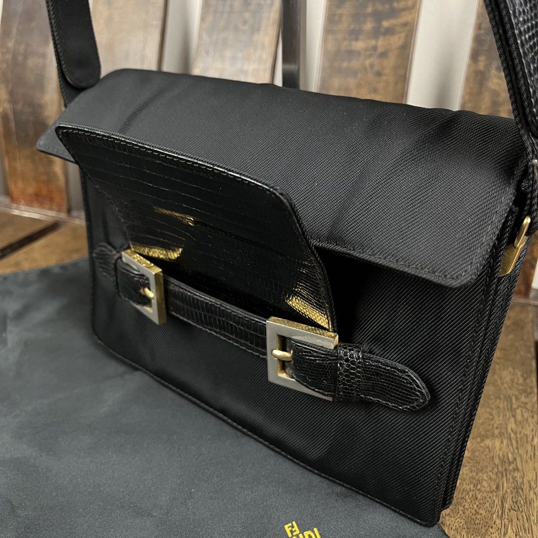 Fendi 1990s Nylon Lizzard Embossed Leather Shoulder Bag (Category: Luxury Bags & Wallets) located in Quezon City. Submitted by forgarments (Listing ID 1470861680, Image 3). Description: Fendi 1990s Nylon Lizzard Embossed Leather Shoulder Bag Excellent Condition - with dust bag Width: 23 Cm Height: 16 Cm Depth: 9 Cm Handle drop: 20-22 Cm - Snap button Adjustment Strap - Dual silver tone buckle strap accent that hold the slip closure of the flap - 