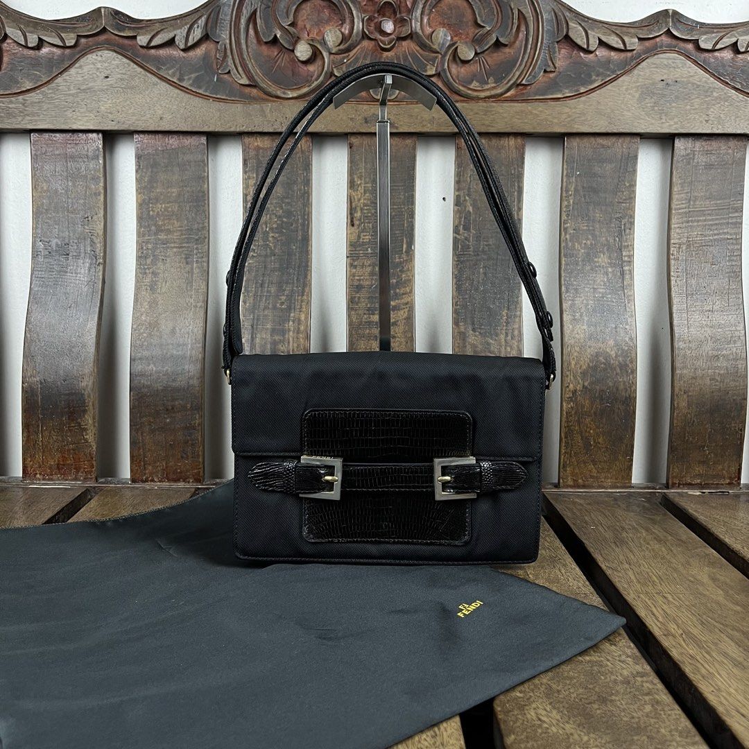 Fendi 1990s Nylon Lizzard Embossed Leather Shoulder Bag (Category: Luxury Bags & Wallets) located in Quezon City. Submitted by forgarments (Listing ID 1470861680, Image 1). Description: Fendi 1990s Nylon Lizzard Embossed Leather Shoulder Bag Excellent Condition - with dust bag Width: 23 Cm Height: 16 Cm Depth: 9 Cm Handle drop: 20-22 Cm - Snap button Adjustment Strap - Dual silver tone buckle strap accent that hold the slip closure of the flap - 