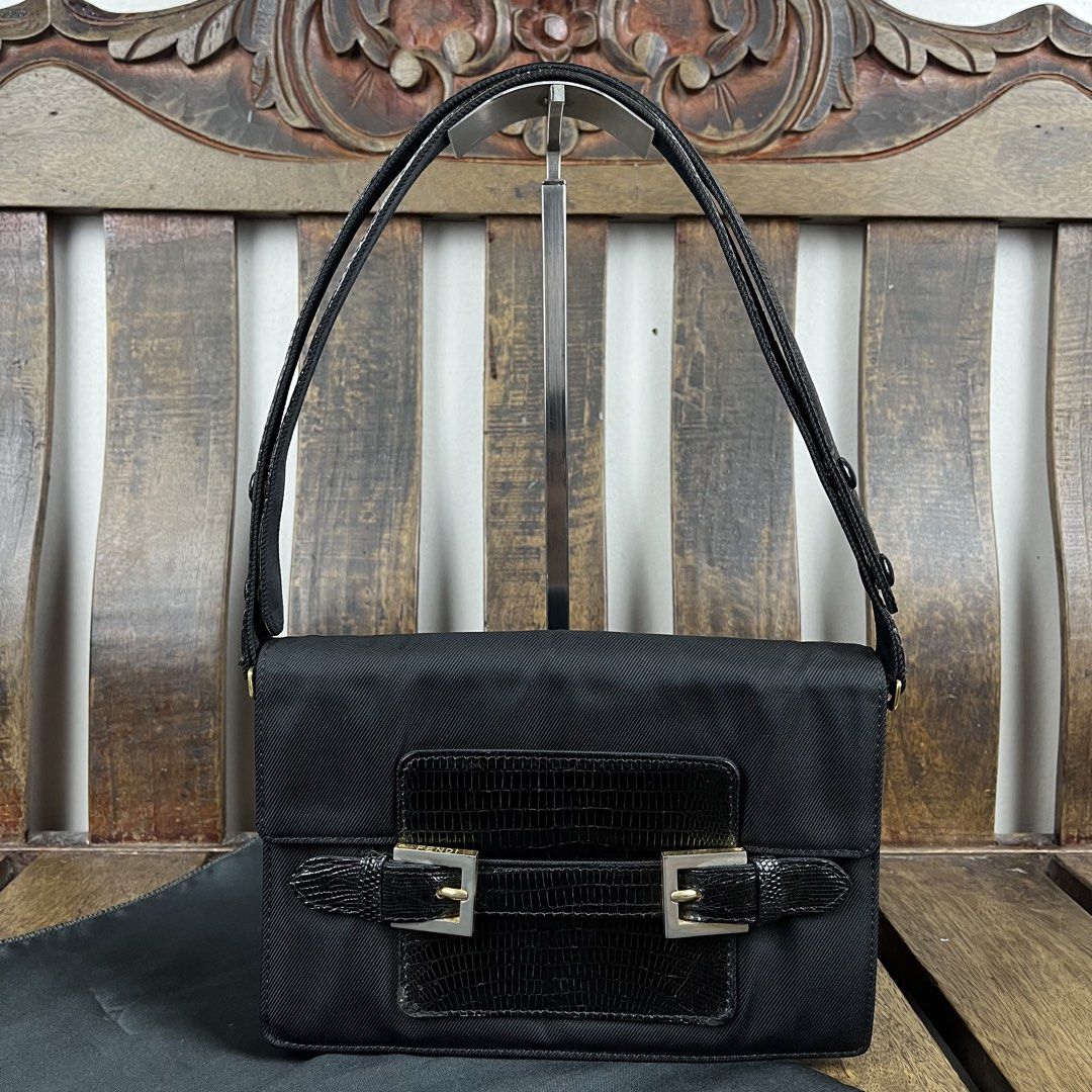 Fendi 1990s Nylon Lizzard Embossed Leather Shoulder Bag (Category: Luxury Bags & Wallets) located in Quezon City. Submitted by forgarments (Listing ID 1470861680, Image 2). Description: Fendi 1990s Nylon Lizzard Embossed Leather Shoulder Bag Excellent Condition - with dust bag Width: 23 Cm Height: 16 Cm Depth: 9 Cm Handle drop: 20-22 Cm - Snap button Adjustment Strap - Dual silver tone buckle strap accent that hold the slip closure of the flap - 