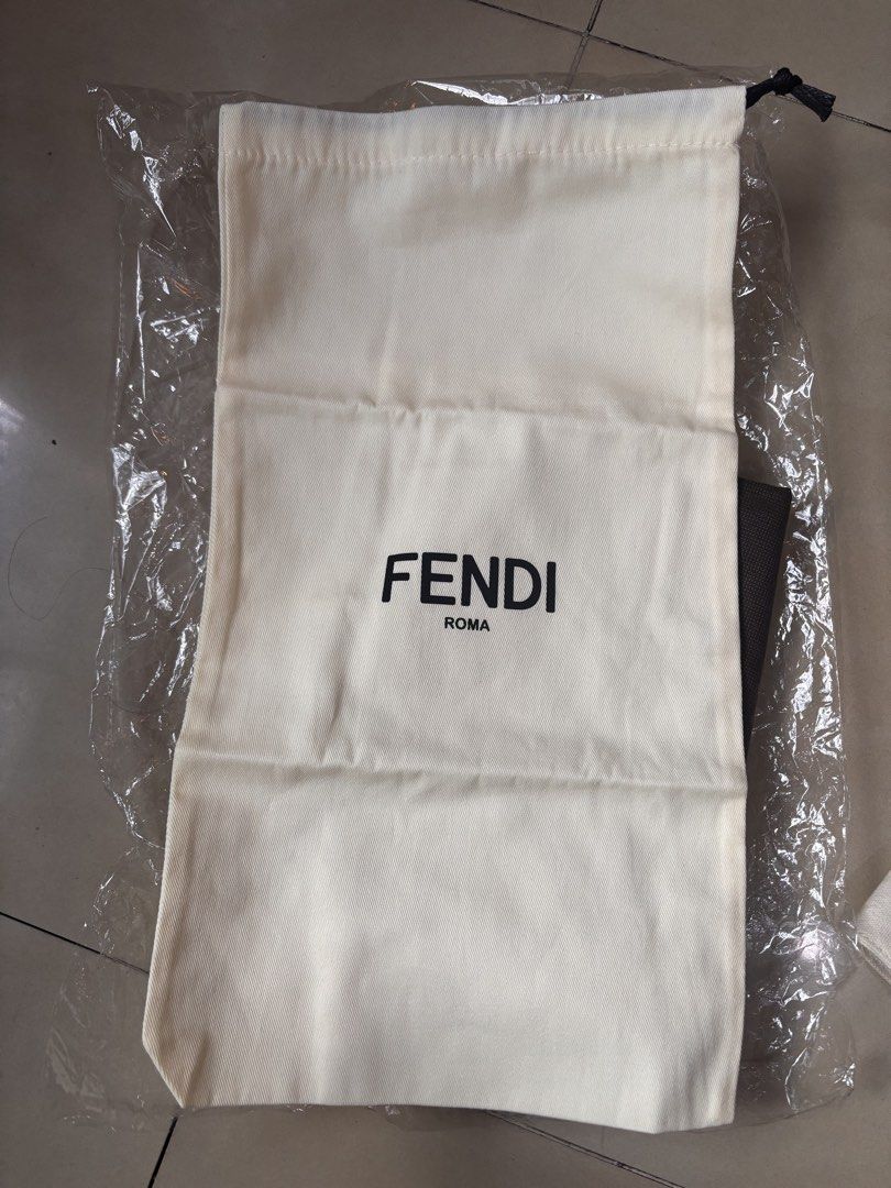 Fendi Dust Bag (Category: Luxury Bags & Wallets) located in Caloocan City. Submitted by pnkcshmr (Listing ID 1470746622, Image 1). Description: - Authentic Fendi dust bag in cream cotton fabric - Features the iconic black Fendi Roma logo stamped on the front - Secure drawstring closure with black cord - Kept brand new and clean inside plastic wrapping - Ideal for storing and protecting your luxury bags -approx 9”x17”.