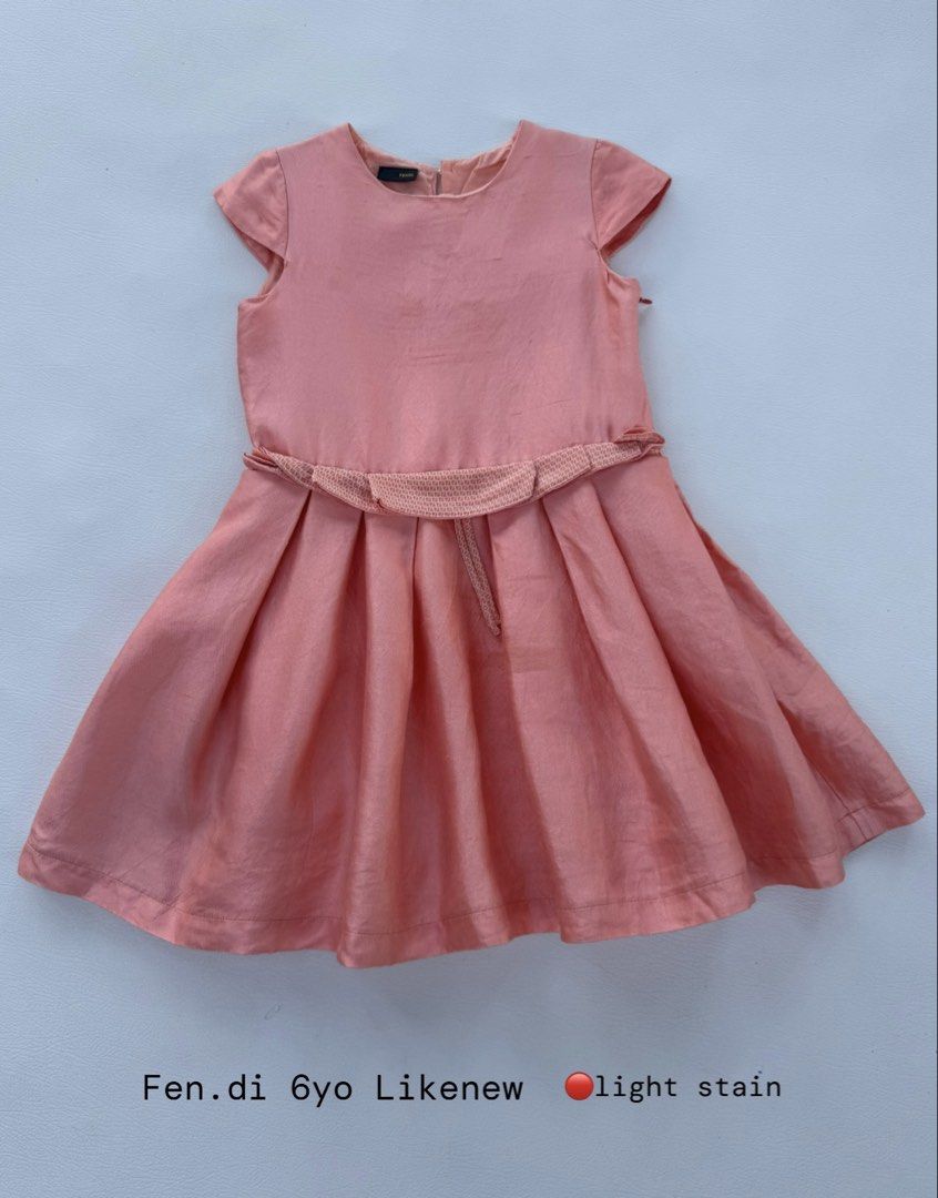 Fendi Pink Dress 6yo (Category: Babies & Kids Fashion) located in Pozorrubio. Submitted by izaykite2g (Listing ID 1470771409, Image 1). Description: - Brand: Fendi - Color: Pink - Size: Fits 6-year-olds - Design: Cap sleeves, rounded neckline, textured fabric belt at the waist, and a flared pleated skirt - Flaw: Light stain near the upper chest area (please check photos).