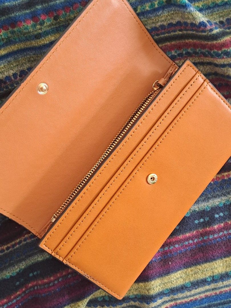 Fendi Roma Long Wallet (Category: Wallets & Card holders) located in Narra. Submitted by jervs29corner (Listing ID 1470833680, Image 3). Description: - Brand/Model: Fendi Roma Wallet - Closure: Flap with secure snap button - Interior Storage: Multiple card slots, spacious bill compartments, and a convenient zippered coin pocket - Details: Stamped Fendi logo inside with clean, premium stitching all around - Condition/Usage: Great daily companion t