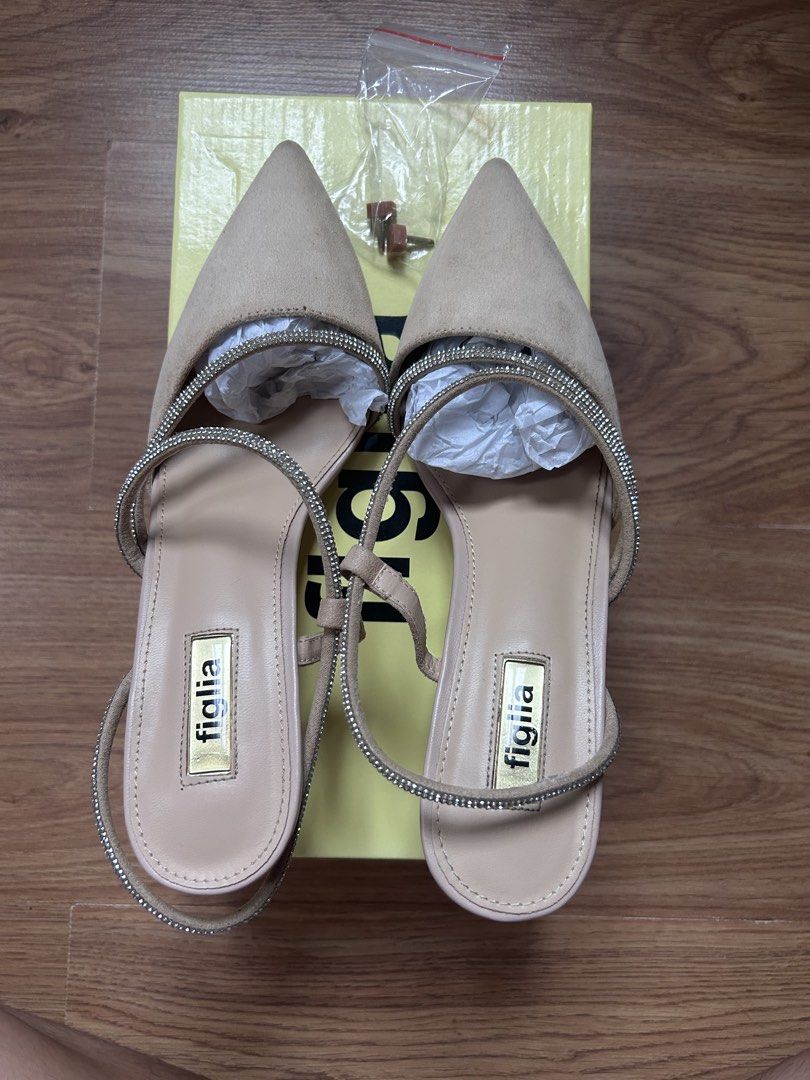 Figlia Fergie Beige Kitten Heels Size 39 (Category: Heels) located in Bacoor. Submitted by Claudine (Listing ID 1470822403, Image 1). Description: - Brand/Model: Figlia Fergie Heels - Color/Material: Beige Suede - Size: 39 - Style: Pointed toe with sparkly rhinestone ankle and foot straps, kitten heel - Inclusions: Original yellow box and extra heel tips - Condition: Soles show wear from previous use USED ONLY ONCE.