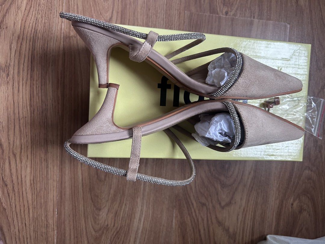 Figlia Fergie Beige Kitten Heels Size 39 (Category: Heels) located in Bacoor. Submitted by Claudine (Listing ID 1470822403, Image 2). Description: - Brand/Model: Figlia Fergie Heels - Color/Material: Beige Suede - Size: 39 - Style: Pointed toe with sparkly rhinestone ankle and foot straps, kitten heel - Inclusions: Original yellow box and extra heel tips - Condition: Soles show wear from previous use USED ONLY ONCE.