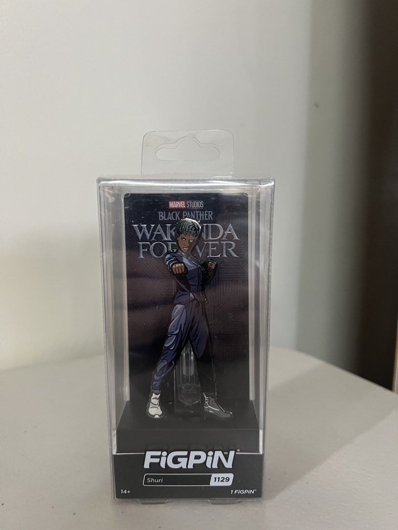 FiGPiN Marvel Studios Black Panther Wakanda Forever - Shuri 1129 (Category: Figurines & Statues) located in Quezon City. Submitted by xeraphinasy (Listing ID 1470781496, Image 1). Description: - Authentic FiGPiN collectable pin (#1129) - Features Shuri from Marvel Studios' Black Panther: Wakanda Forever - Brand new and unopened in original packaging - Includes clear acrylic display case - Perfect addition for any Marvel or pin collection.
