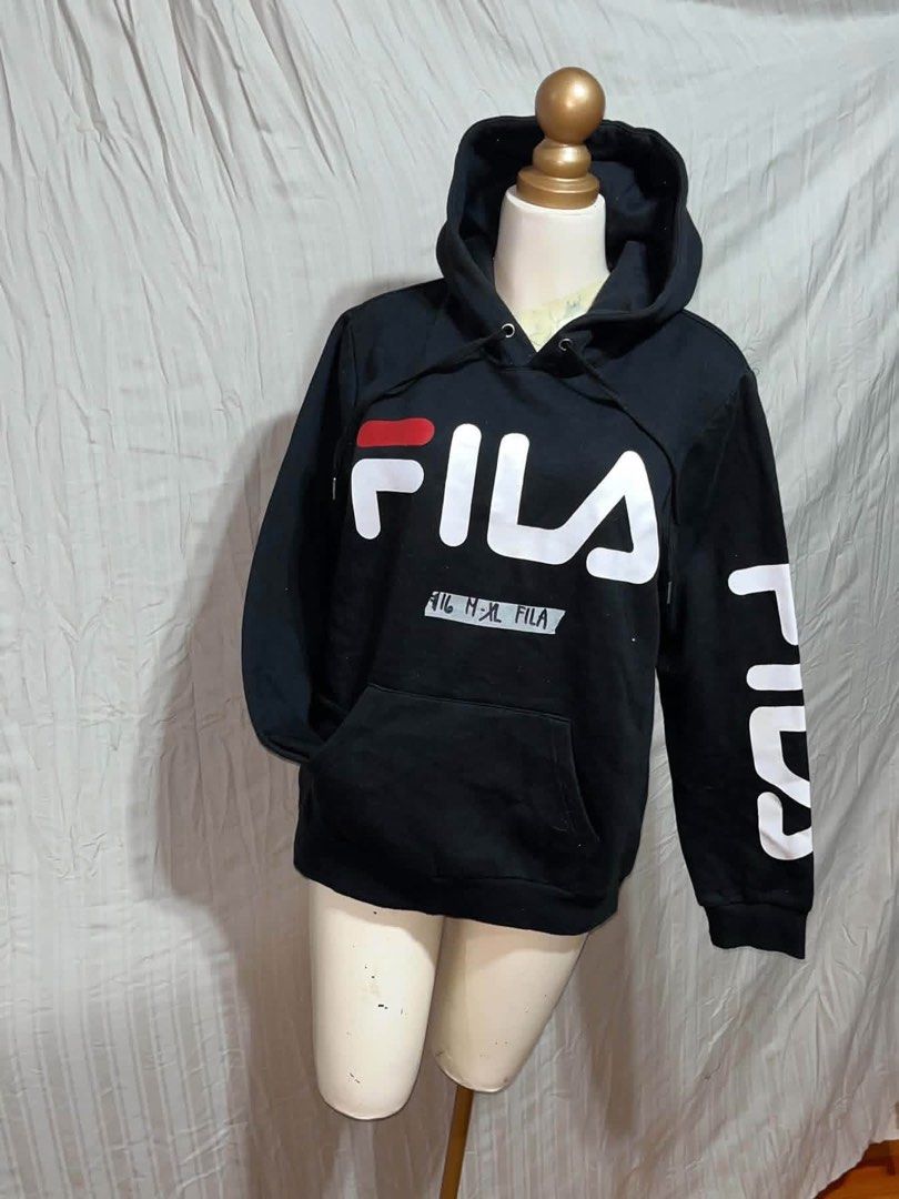 Fila Black Hoodie with Logo Print (Category: Hoodies) located in General Trias. Submitted by crissy9053136 (Listing ID 1470761321, Image 1). Description: - Authentic black Fila hoodie - Bold white and red chest logo with matching Fila left sleeve print - Cozy soft fleece lining with standard fit - Adjustable drawstring hood and convenient front kangaroo pocket - Classic sportswear piece, perfect for everyday casual wear.