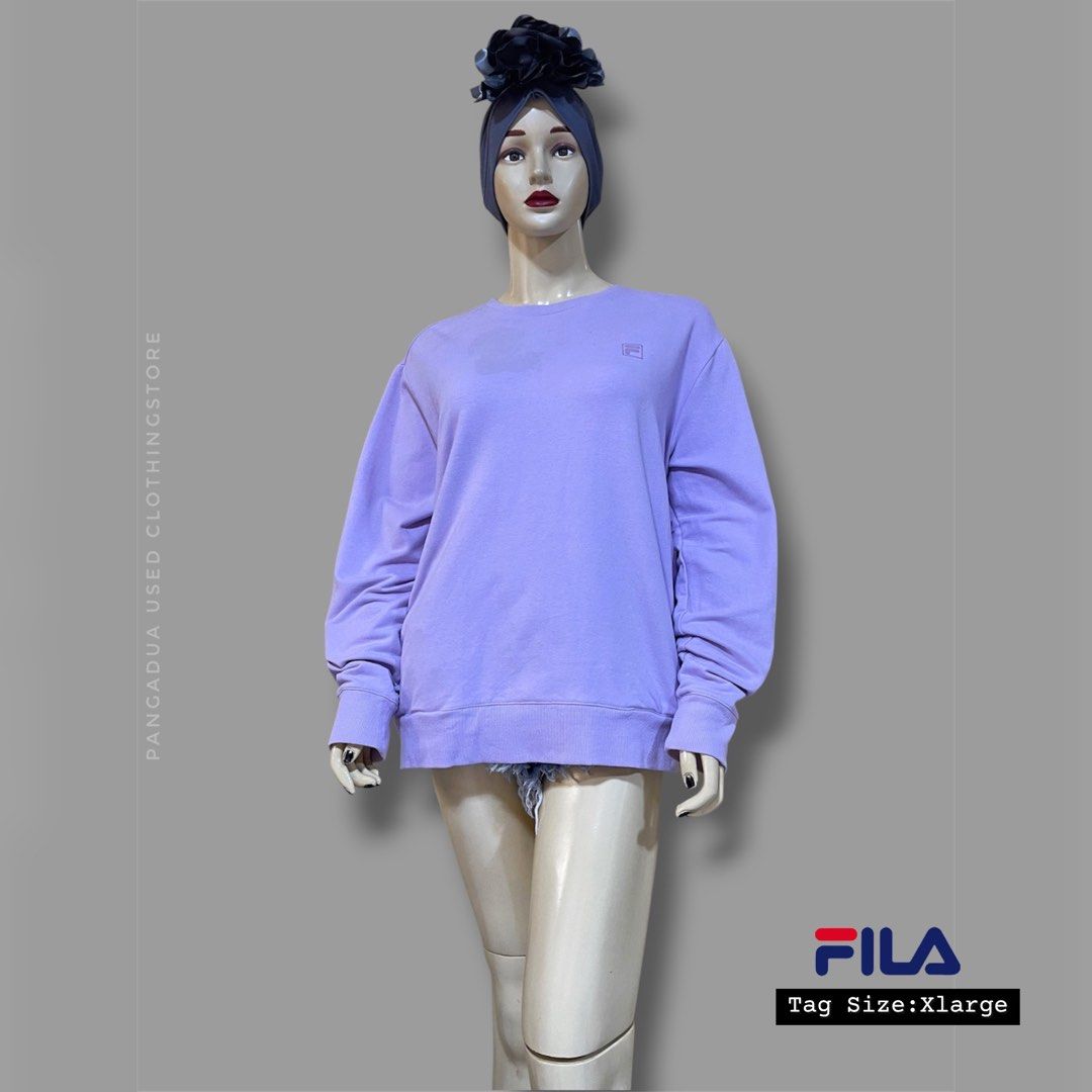 Fila Purple Sweatshirt (Category: Coats, Jackets and Outerwear) located in Naga. Submitted by 2ndusedclothingstore (Listing ID 1470851968, Image 1). Description: - Brand: Fila - Color: Light Lavender / Purple - Size: Tagged US/F XL, UK 50, D 42, CAN XL/TG - Material: Clean French terry interior fabric - Design: Classic pullover, crew neckline, long sleeves, subtle embroidered chest logo - Ribbed details: Collar, cuffs, and hem - Condition: Excell