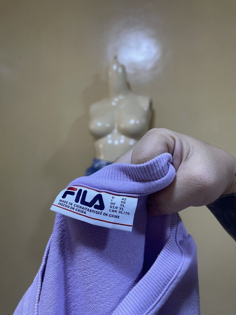 Fila Purple Sweatshirt (Category: Coats, Jackets and Outerwear) located in Naga. Submitted by 2ndusedclothingstore (Listing ID 1470851968, Image 2). Description: - Brand: Fila - Color: Light Lavender / Purple - Size: Tagged US/F XL, UK 50, D 42, CAN XL/TG - Material: Clean French terry interior fabric - Design: Classic pullover, crew neckline, long sleeves, subtle embroidered chest logo - Ribbed details: Collar, cuffs, and hem - Condition: Excell