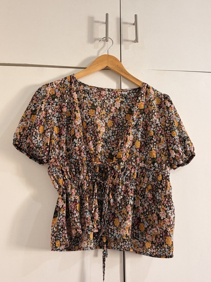 Floral Print Short Sleeve Tie Front Blouse (Category: Blouses) located in Marikina City. Submitted by _bananahanaa (Listing ID 1470796567, Image 1). Description: - Style: Short sleeve floral print blouse with a deep V-neckline - Details: Double tie-front closure with adjustable strings - Fit: Elasticized waist for a flattering, fitted shape - Material: Lightweight and breathable fabric, flowy - fits xs-medium frames.
