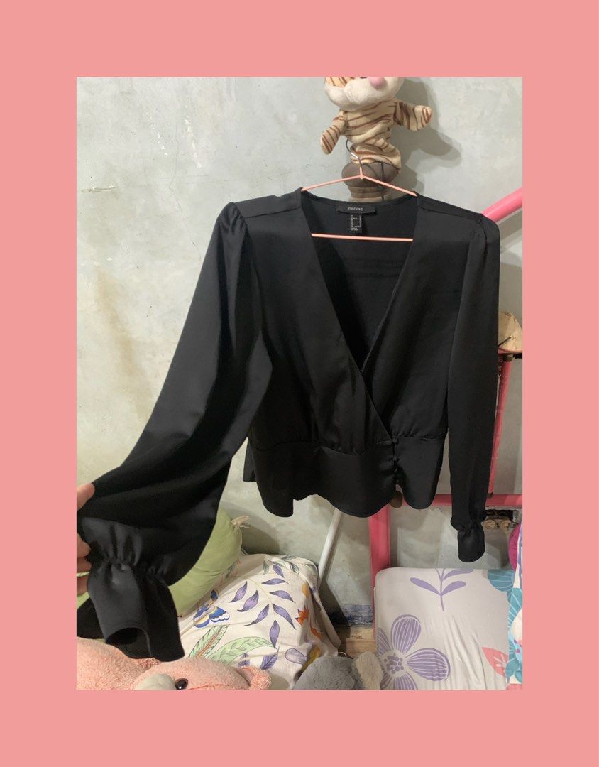 Forever 21 Black Long Sleeve Wrap Blouse Size L (Category: Longsleeves) located in Mandaluyong City. Submitted by mamalove70 (Listing ID 1470784300, Image 1). Description: Forever 21 black long sleeve blouse. Wrap front style with side buttons and gathered peplum hem. Ruffled cuffs on the long sleeves. Deep v-neckline. Size L tag on the collar. Made in Vietnam. Clean fabric with smooth finish. Great piece to pair with high-waisted jeans or skirts