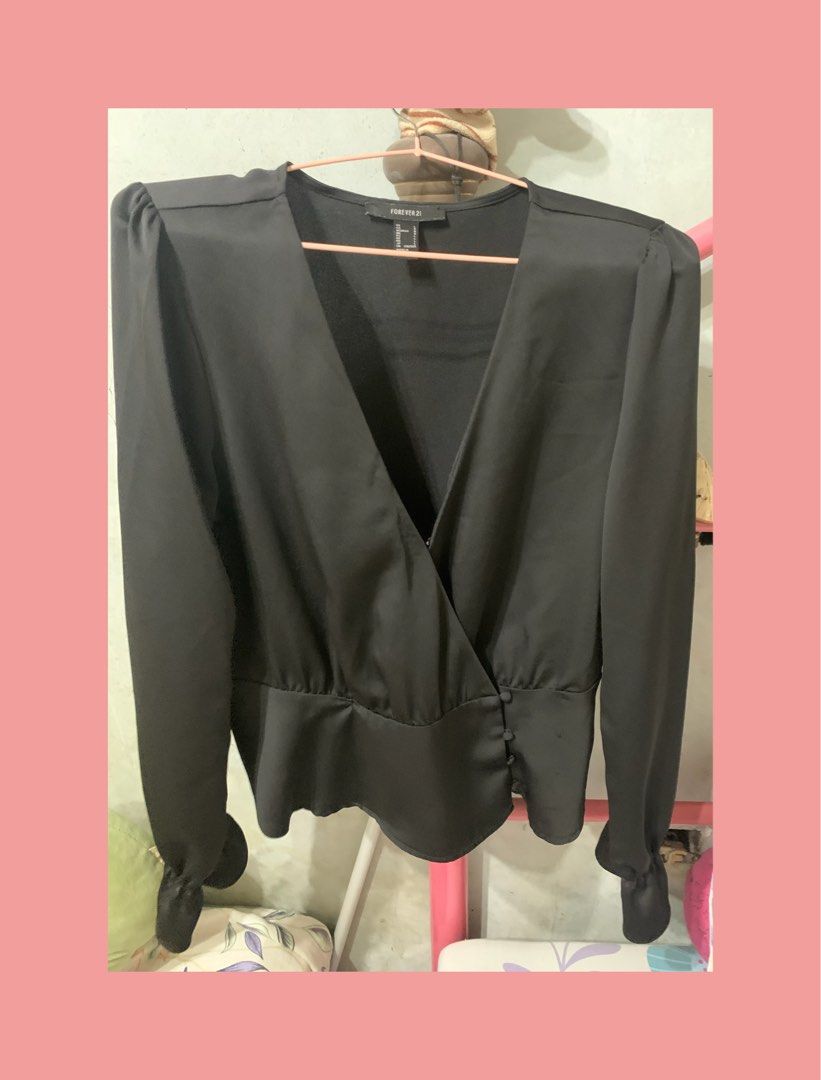 Forever 21 Black Long Sleeve Wrap Blouse Size L (Category: Longsleeves) located in Mandaluyong City. Submitted by mamalove70 (Listing ID 1470784300, Image 2). Description: Forever 21 black long sleeve blouse. Wrap front style with side buttons and gathered peplum hem. Ruffled cuffs on the long sleeves. Deep v-neckline. Size L tag on the collar. Made in Vietnam. Clean fabric with smooth finish. Great piece to pair with high-waisted jeans or skirts