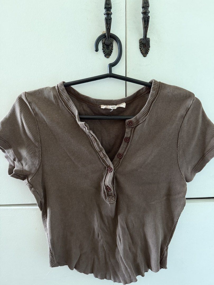 Forever 21 Brown Ribbed Button-Down Crop Top Size M (Category: Shirts) located in Manila. Submitted by mnlclaudia (Listing ID 1470791095, Image 1). Description: Brown ribbed crop top from Forever 21. Size M, made in Bangladesh. Short sleeves, scoop neckline with functional brown buttons down the front. Scalloped hemline. Stretchy cotton blend material. Worn a few times, washed and stored properly. Fits true to size, great basic piece for everyday