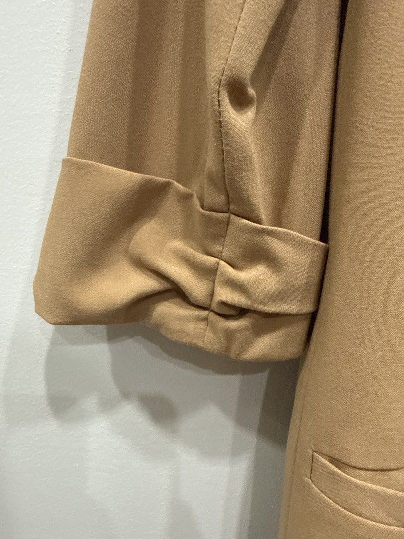 Forever 21 Camel Brown Blazer Size S (Category: Coats, Jackets and Outerwear) located in Taguig. Submitted by bau375 (Listing ID 1470795924, Image 3). Description: - Brand: Forever 21 - Color: Camel Brown - Size: S (tag attached) - Closure: Single button front - Details: Cute bow pattern inner lining, ruched sleeves with gathered cuffs - Pockets: Two front pockets plus a small chest pocket - Style: Great for layering over workwear or casual outfi