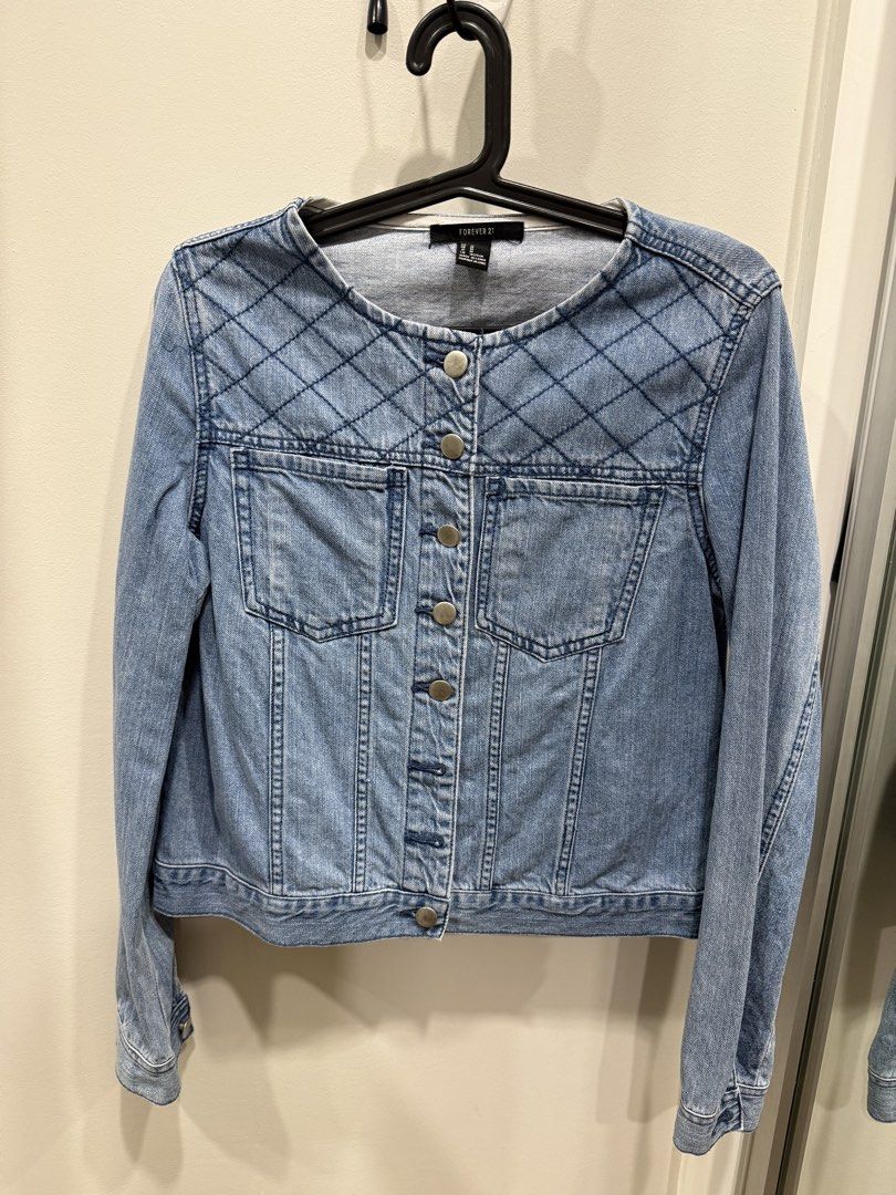 Forever 21 Quilted Denim Jacket Size M (Category: Coats, Jackets and Outerwear) located in Taguig. Submitted by bau375 (Listing ID 1470891267, Image 1). Description: - Brand: Forever 21 - Size: M - Color: Light wash blue - Details: Quilted upper chest stitching, metallic buttons, button-up front, two chest pockets, and button cuffs - Condition: Excellent staple piece, perfect for layering.