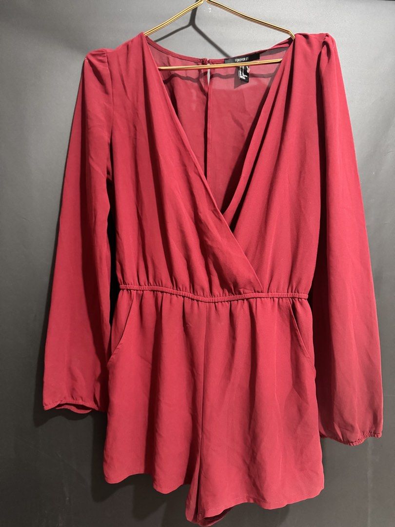 Forever 21 Red Long Sleeve Romper Size M (Category: Rompers) located in Taguig. Submitted by patrisheaaa (Listing ID 1470859249, Image 1). Description: - Brand: Forever 21 - Size: M - Color: Maroon - Material: Lightweight fabric (Made in Vietnam) - Features: Long sleeves with elastic cuffs, wrap-style V-neckline, elastic waistband, and side pockets - Loc: Taguig.