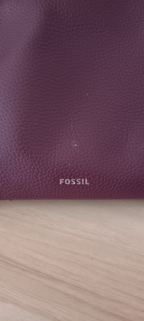 Fossil Burgundy Leather Shoulder Bag (Category: Shoulder Bags) located in Marikina City. Submitted by clivia_mommymade (Listing ID 1470848570, Image 2). Description: - Brand: Fossil - Material: Rich burgundy pebble leather - Hardware: Gold-tone - Strap: Adjustable for custom fit - Closure: Secure top zip - Interior: Brown fabric lining with multiple slip and zip pockets - Inclusions: Care booklet included - Condition: Well-maintained and stylish 