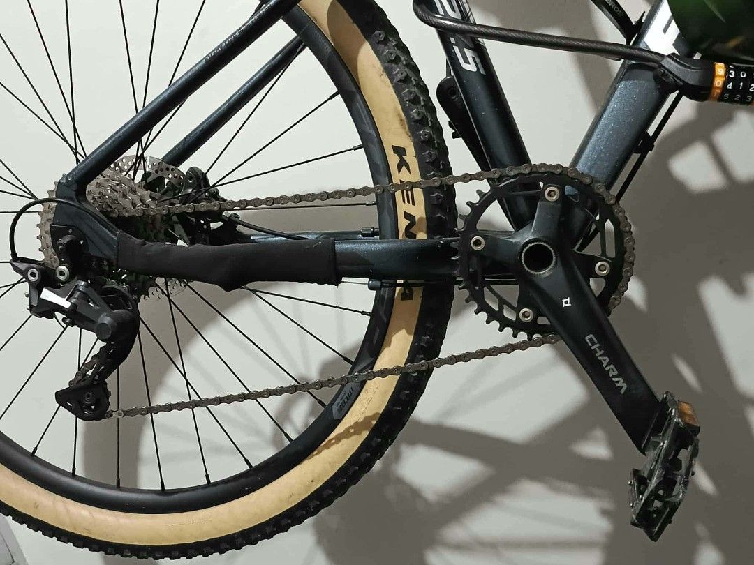 Foxter 27.5 Mountain Bike (Category: Bicycles) located in Marikina City. Submitted by wisebuytoo (Listing ID 1470823893, Image 3). Description: - Bike Model: Foxter Mountain Bike with 27.5-inch wheels - Tires: Kenda tan wall tires - Frame: Dark gray with prominent silver branding - Components: Front suspension fork, reliable disc brakes, and Charm crankset - Cockpit: Foxter stem on handlebars - Protection: Chainstay protector installed on rear fr