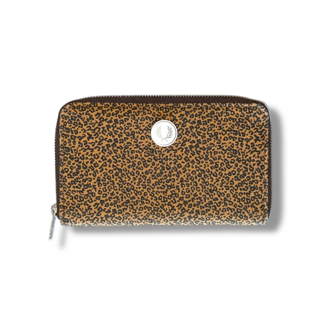 Fred Perry Leopard Print Zip Around Wallet (Category: Wallets & Card holders) located in Kidapawan. Submitted by azythrift (Listing ID 1470819502, Image 1). Description: - Brand: Fred Perry - Condition: Brand new with tags attached, super clean inside and out - Pattern/Design: Bold leopard print with signature silver-tone laurel wreath emblem - Interior: Brown lining with multiple card slots, ID window, and a secure zippered coin compartment - Cl