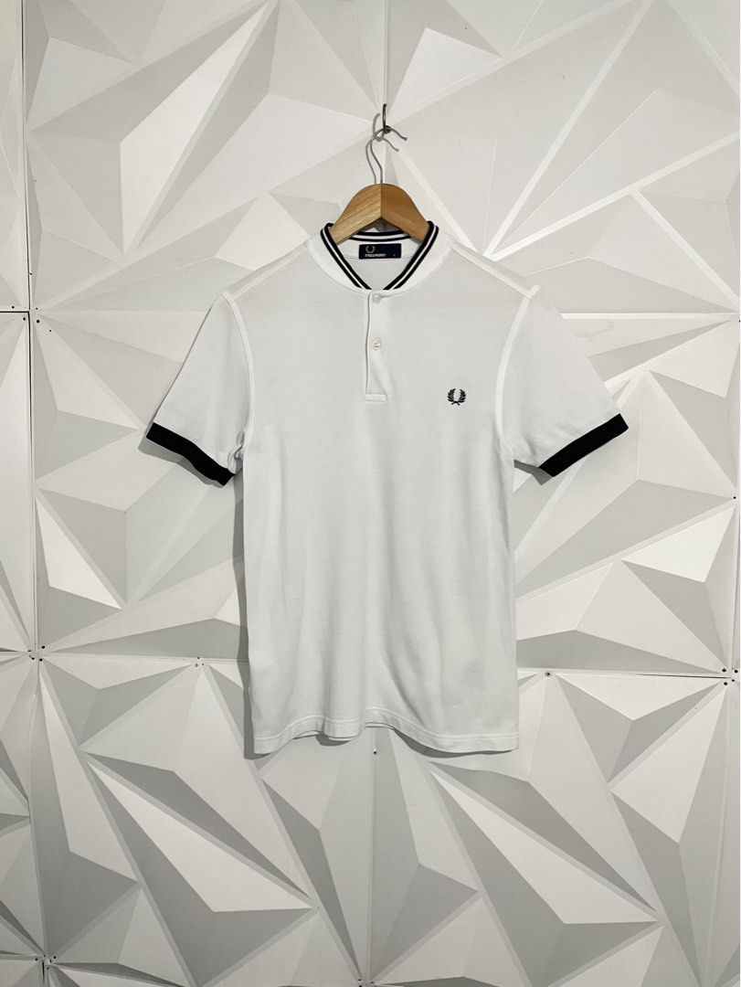 Fred Perry White Polo Shirt (Category: Tshirts & Polo Shirts ) located in Cabuyao City. Submitted by ParadisethriftedPh (Listing ID 1470924492, Image 1). Description: Cr: 9.8/10 Dimensions W: 18.5 L: 26 - Brand: Fred Perry - Color: White with black tipping on collar and cuffs - Size: S - Material: 100% cotton (Made in China) - Details: Classic two-button placket, embroidered black laurel wreath on chest - Condition: Clean fabric, internal tags at