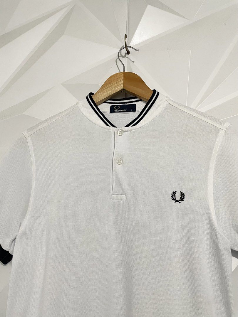 Fred Perry White Polo Shirt (Category: Tshirts & Polo Shirts ) located in Cabuyao City. Submitted by ParadisethriftedPh (Listing ID 1470924492, Image 3). Description: Cr: 9.8/10 Dimensions W: 18.5 L: 26 - Brand: Fred Perry - Color: White with black tipping on collar and cuffs - Size: S - Material: 100% cotton (Made in China) - Details: Classic two-button placket, embroidered black laurel wreath on chest - Condition: Clean fabric, internal tags at