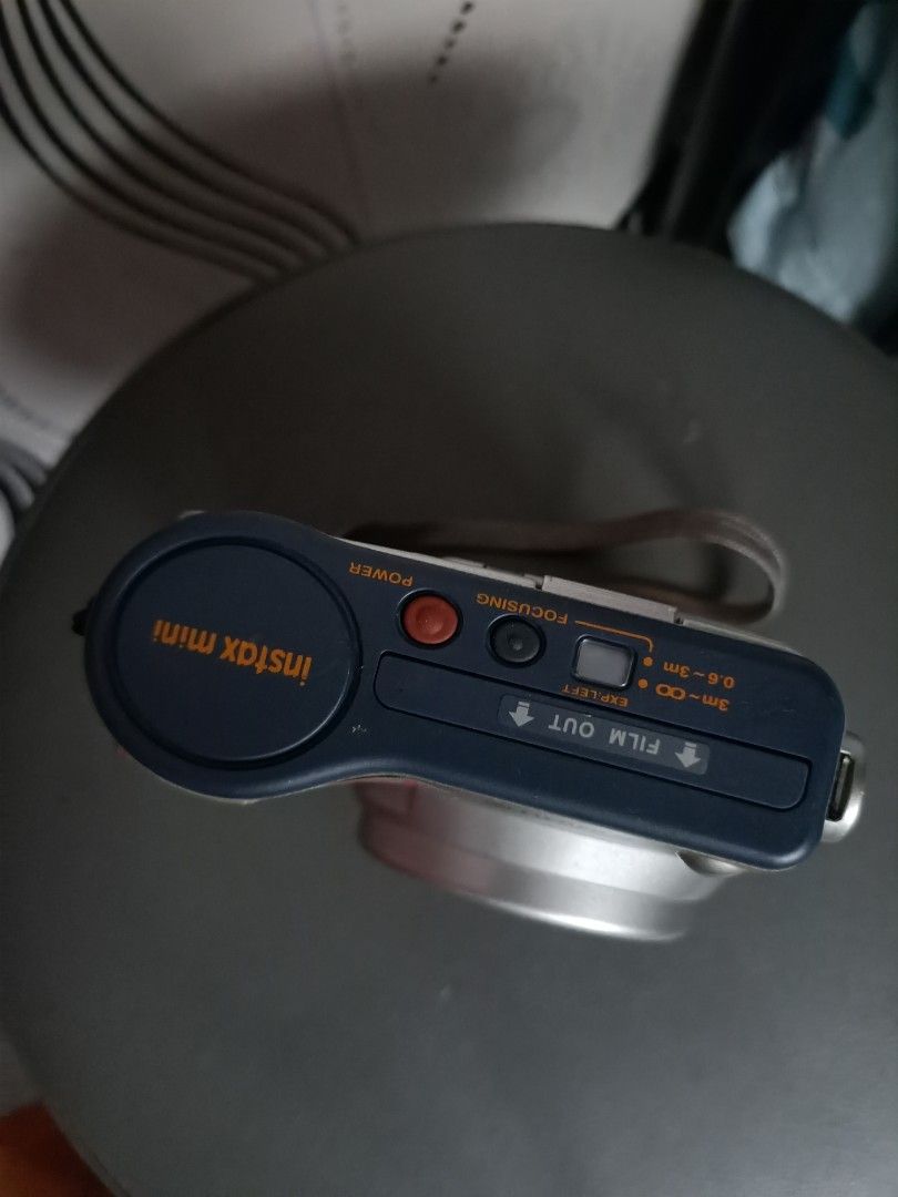 Fujifilm Instax Mini 10 Instant Camera Silver (Category: Cameras) located in Taguig. Submitted by grandfish_55ab5c (Listing ID 1470882611, Image 2). Description: - Model: Silver Fujifilm Instax Mini 10 instant camera - Lens: Fujinon 60mm lens - Focus: Manual focus settings from 0.6m to infinity - Flash & Exposure: Built-in flash with lighten and darken controls - Extras: Wrist strap attached included - Power: Side battery compartment (easy access