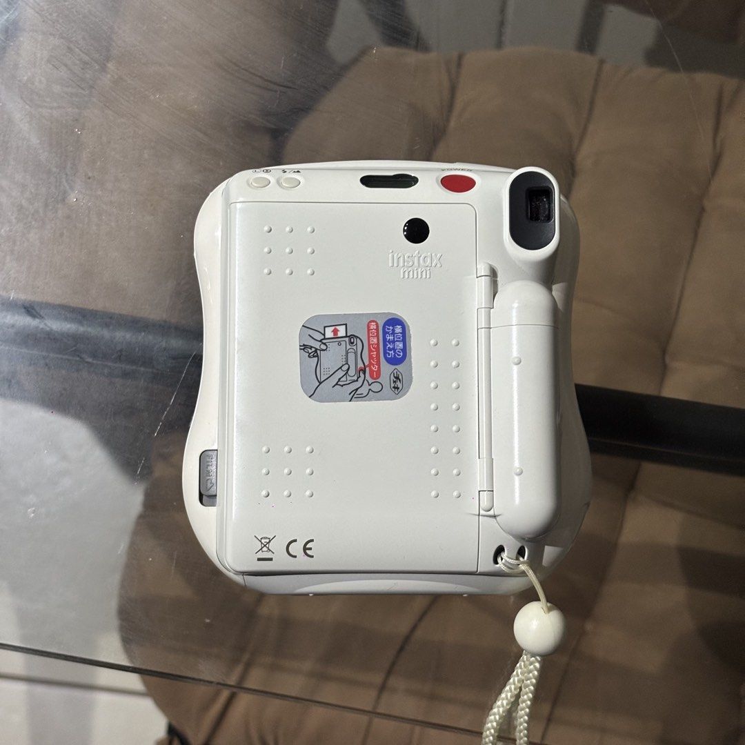 Fujifilm Instax Mini 25 Instant Camera White (Category: Cameras) located in Manila. Submitted by lyzyuh (Listing ID 1470800549, Image 2). Description: - Model: Fujifilm Instax Mini 25 - Color: White and Light Yellow - Lens: 60mm with built-in flash - Features: Dual shutter buttons for horizontal and vertical shooting - Condition: Fully functional, clean film chamber - Inclusions: Matching wrist strap with white bead - Film type: Uses Instax Mini 