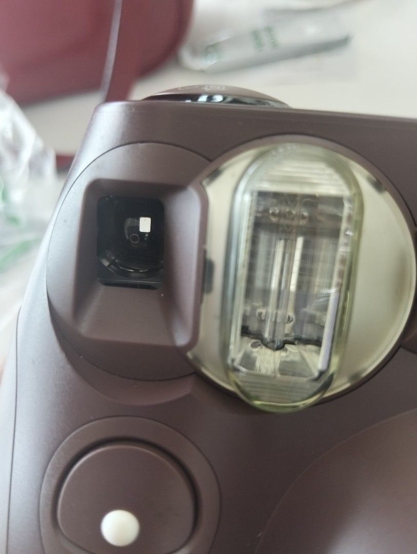 Fujifilm Instax Mini 7S Brown Instant Camera (Category: Cameras) located in Marikina City. Submitted by aisha.escarez21 (Listing ID 1470903925, Image 3). Description: - Model: Fujifilm Instax Mini 7S Instant Camera - Color: Chocolate Brown - Lens: Fujinon 60mm (0.6m to infinity focus) - Exposure: Manual adjustment dial on top - Condition: Clean film chamber and battery compartment - Film Type: Uses standard Instax Mini film - Perfect for: Parties