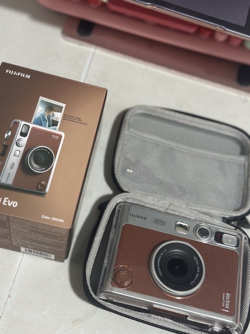 Fujifilm Instax Mini Evo Brown (Category: Cameras) located in Manila. Submitted by ellelements (Listing ID 1470930460, Image 1). Description: INSTAX MINI EVO — Vintage Brown Letting go of my Instax Mini Evo 🤎 ❗️Complete inclusions Complete original accessories FREE hard pouch FREE tempered glass FREE clear case With proof of purchase from Fujifilm ✨ Good condition, no issues, rarely used ✨ RFS: Impulse buy. Hindi ko po talaga siya nagagamit. 📩 