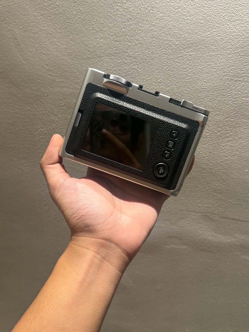 Fujifilm Instax Mini Evo Hybrid Instant Camera with Case (Category: Cameras) located in Pateros City. Submitted by maurjss (Listing ID 1470908845, Image 3). Description: - Model: Fujifilm Instax Mini Evo Hybrid Instant Camera - Color: Classic Silver & Black finish - Condition: Tested and fully functional - Features: Rear LCD screen with intuitive control buttons, print digital photos instantly - Inclusions: Matching black leatherette half case wi