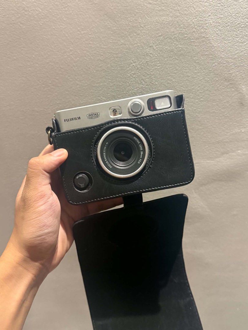 Fujifilm Instax Mini Evo Hybrid Instant Camera with Case (Category: Cameras) located in Pateros City. Submitted by maurjss (Listing ID 1470908845, Image 1). Description: - Model: Fujifilm Instax Mini Evo Hybrid Instant Camera - Color: Classic Silver & Black finish - Condition: Tested and fully functional - Features: Rear LCD screen with intuitive control buttons, print digital photos instantly - Inclusions: Matching black leatherette half case wi