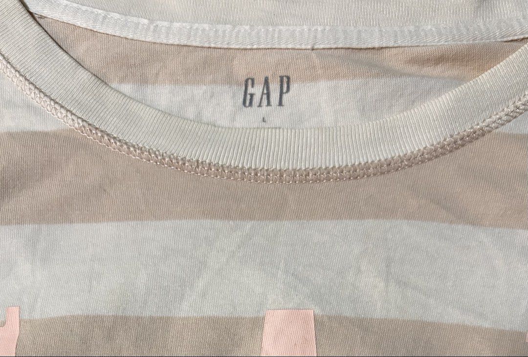 GAP (Category: Shirts) located in Davao. Submitted by sart0ria85 (Listing ID 1470867614, Image 3). Description: Short sleeve striped crop top shirt.Beige and white stripes with pink GAP logo lettering. 100% COTTON MADE IN CHINA 🇨🇳 LARGE. Size 8 VERY GOOD CONDITION (87/100).
