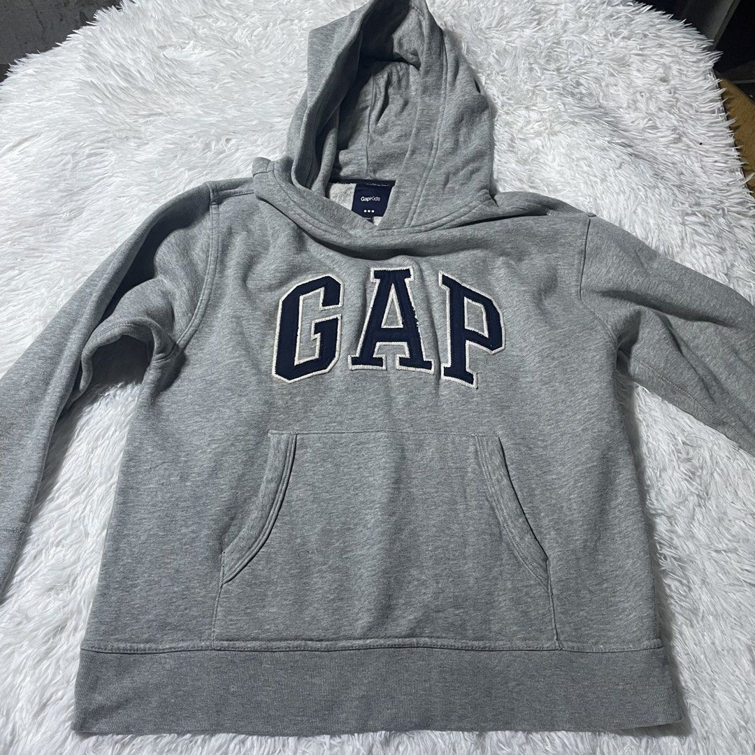 GAP Grey Hoodie Sweatshirt with Front Pocket (Category: Hoodies) located in Batangas. Submitted by strwsherry (Listing ID 1470882671, Image 1). Description: - Features stylish dark blue applique lettering across the chest - Classic pullover style with a spacious kangaroo pocket and matching hood - Comfortable, warm, and perfect for everyday casual wear.
