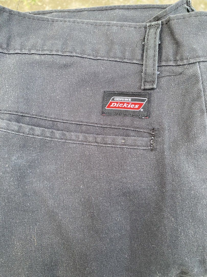 Genuine Dickies Black Work Pants Size 36 (Category: Trousers) located in Imus. Submitted by frootiloots4103 (Listing ID 1470769193, Image 3). Description: - Brand: Genuine Dickies - Color: Black - Size: Waist 36, Length 38, Leg Opening 9.5 inches - Material: Sturdy twill fabric - Features: Classic button closure, back welt pockets with signature logo label - Condition: Pre-owned with a small hole near the leg (see close-up photo).