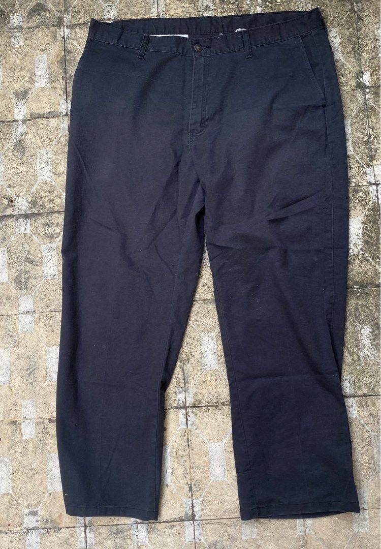Genuine Dickies Black Work Pants Size 36 (Category: Trousers) located in Imus. Submitted by frootiloots4103 (Listing ID 1470769193, Image 2). Description: - Brand: Genuine Dickies - Color: Black - Size: Waist 36, Length 38, Leg Opening 9.5 inches - Material: Sturdy twill fabric - Features: Classic button closure, back welt pockets with signature logo label - Condition: Pre-owned with a small hole near the leg (see close-up photo).
